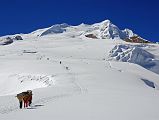 
But what dominates the view from the Mera La (5415m) is, of course, Mera Peak with the trail to Mera High Camp (5770m) snaking up the glacier towards the rock on the left. The climbing route then goes to the right above the long snow ridge in shadow. Mera Peak Central Summit (6461m) is in the middle of the two large snow ridges, and Mera Peak North Summit (6476m) is on top of the right snow ridge.

